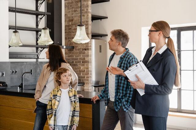 Property manager showing a family of two adults and a child a rental property